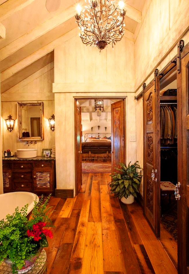 Любители деревенского стиля оценят шкаф-гардероб из тёмного дерева, который в сочетании с изящными деталями интерьера ванной комнаты подчеркивает вкус хозяина