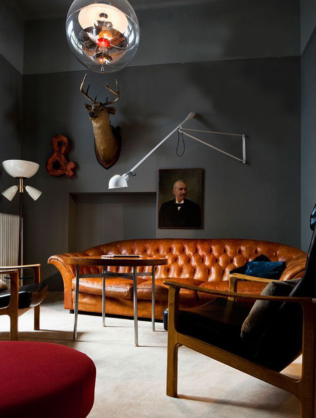 Интерьер гостиной с черными стенами и мебелью в стиле ретро