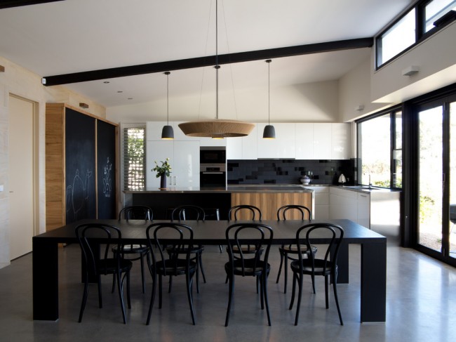 Современная черно-белая, с вкраплениями дерева, кухня в просторном частном дом, построенном в пионерских тенденциях архитектуры