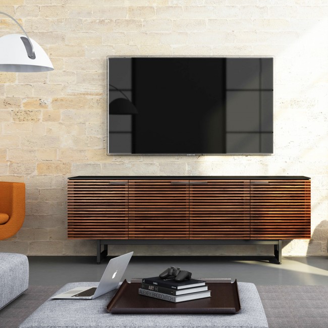 Несмотря на то, что многие модели современных телевизоров крепят на стене, так как они очень тонкие, тумбы под телевизор все равно остаются востребованными