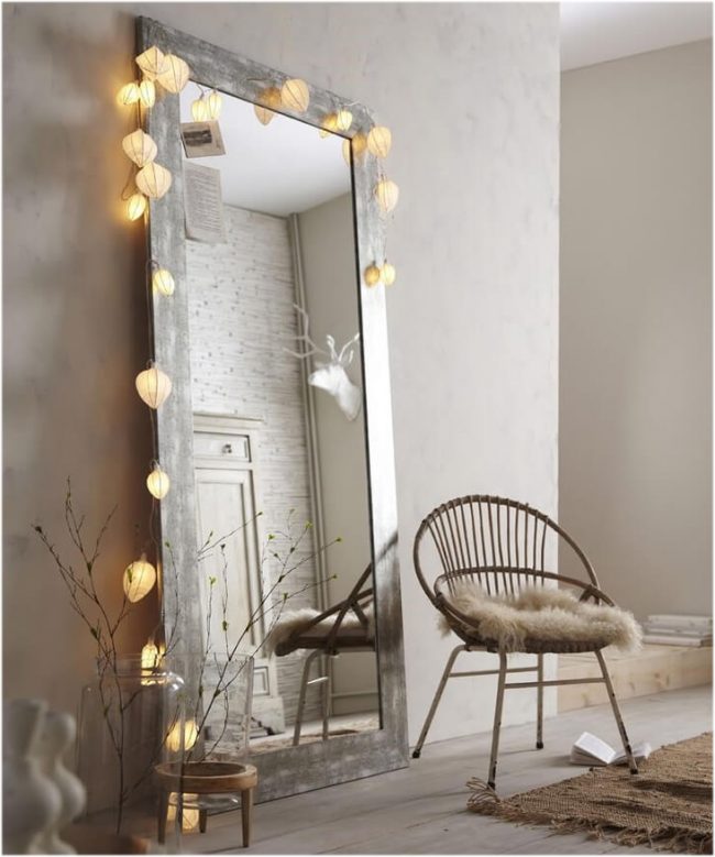 Один из легких вариантов получить зеркало с лампами - это декор крупными гирляндами